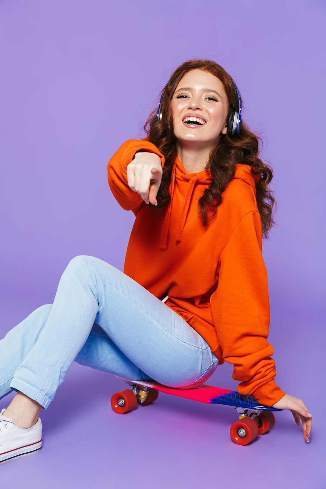 Smiling young woman wearing a headset in a studio